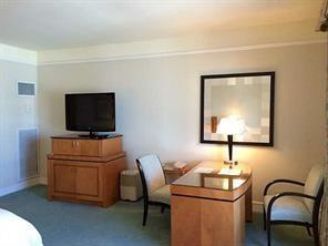 1435 Brickell Avenue, Unit 3211 Miami, FL 33131 - Photo 10 of 16 a living room with furniture and a flat screen tv