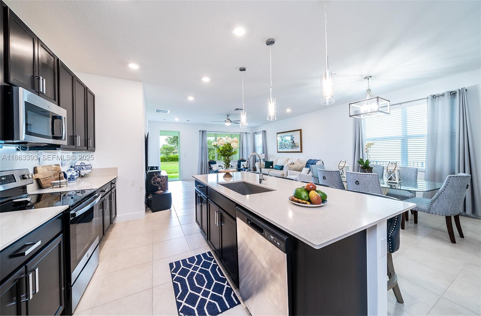 4230 Rosa Drive Deerfield Beach, FL 33064 - Photo 13 of 52 a kitchen with sink stove and refrigerator
