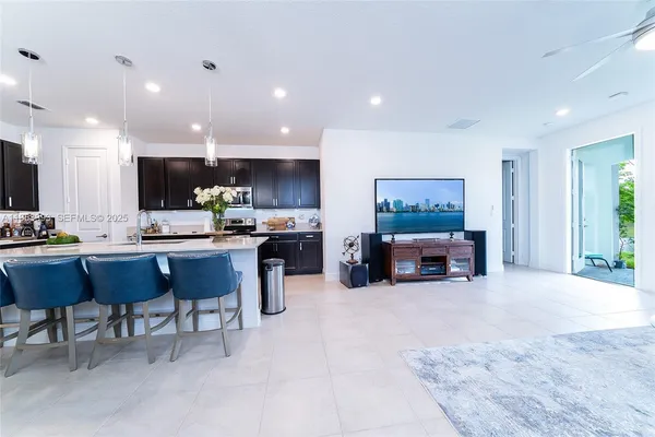 a living room with furniture and kitchen view