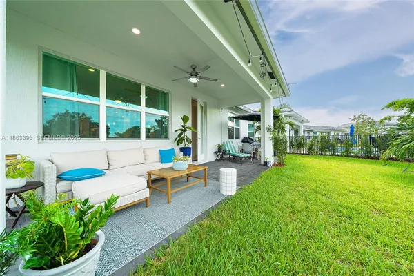 a view of a house with a backyard porch and sitting area