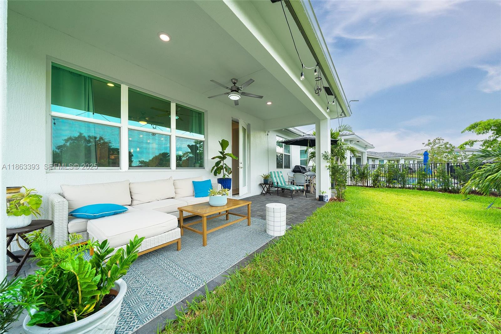 4230 Rosa Drive Deerfield Beach, FL 33064 - Photo 19 of 52 a front view of a house with garden and patio