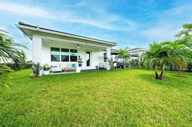 a view of a house with a backyard porch and sitting area