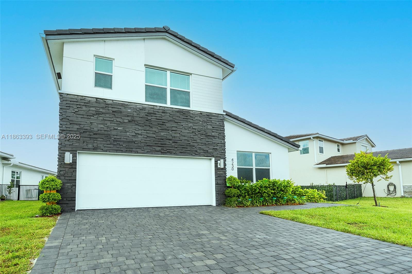 4230 Rosa Drive Deerfield Beach, FL 33064 - Photo 2 of 52 a house view with a garden space