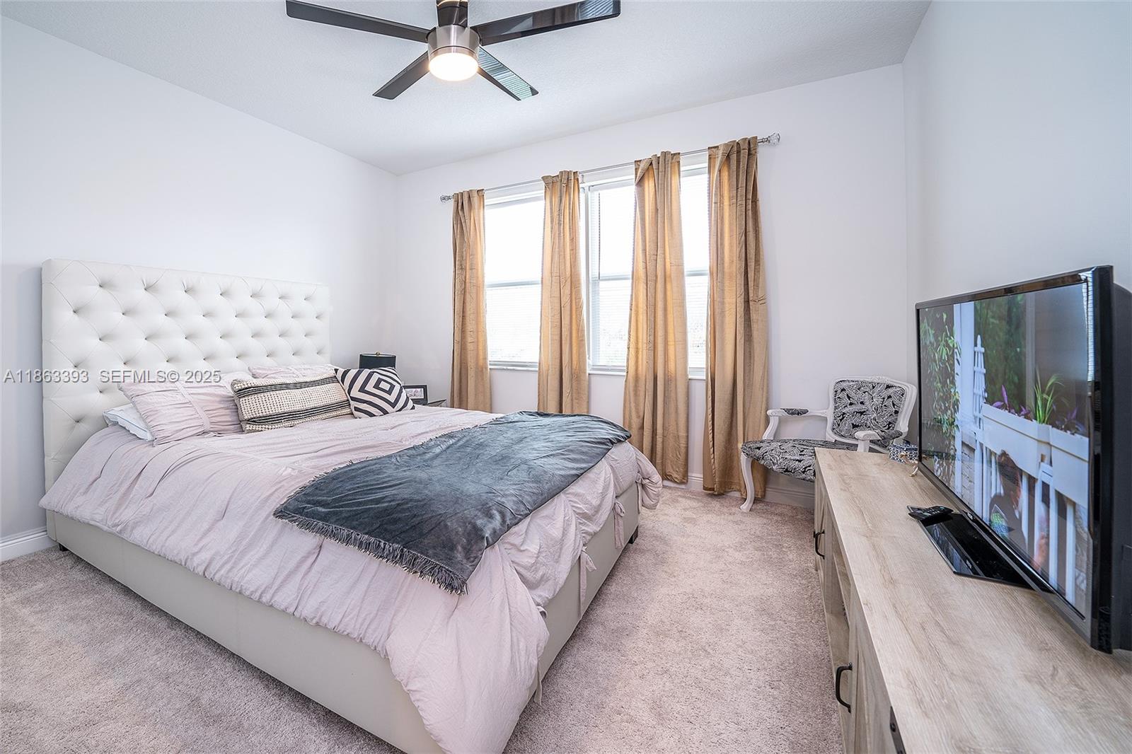 4230 Rosa Drive Deerfield Beach, FL 33064 - Photo 38 of 52 a bedroom with a bed and a flat screen tv