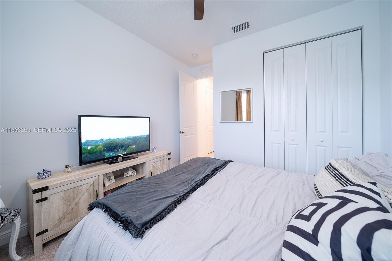 4230 Rosa Drive Deerfield Beach, FL 33064 - Photo 39 of 52 a bedroom with a bed and a flat screen tv