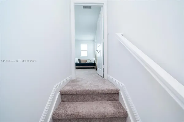 a spacious bedroom with a bed and window