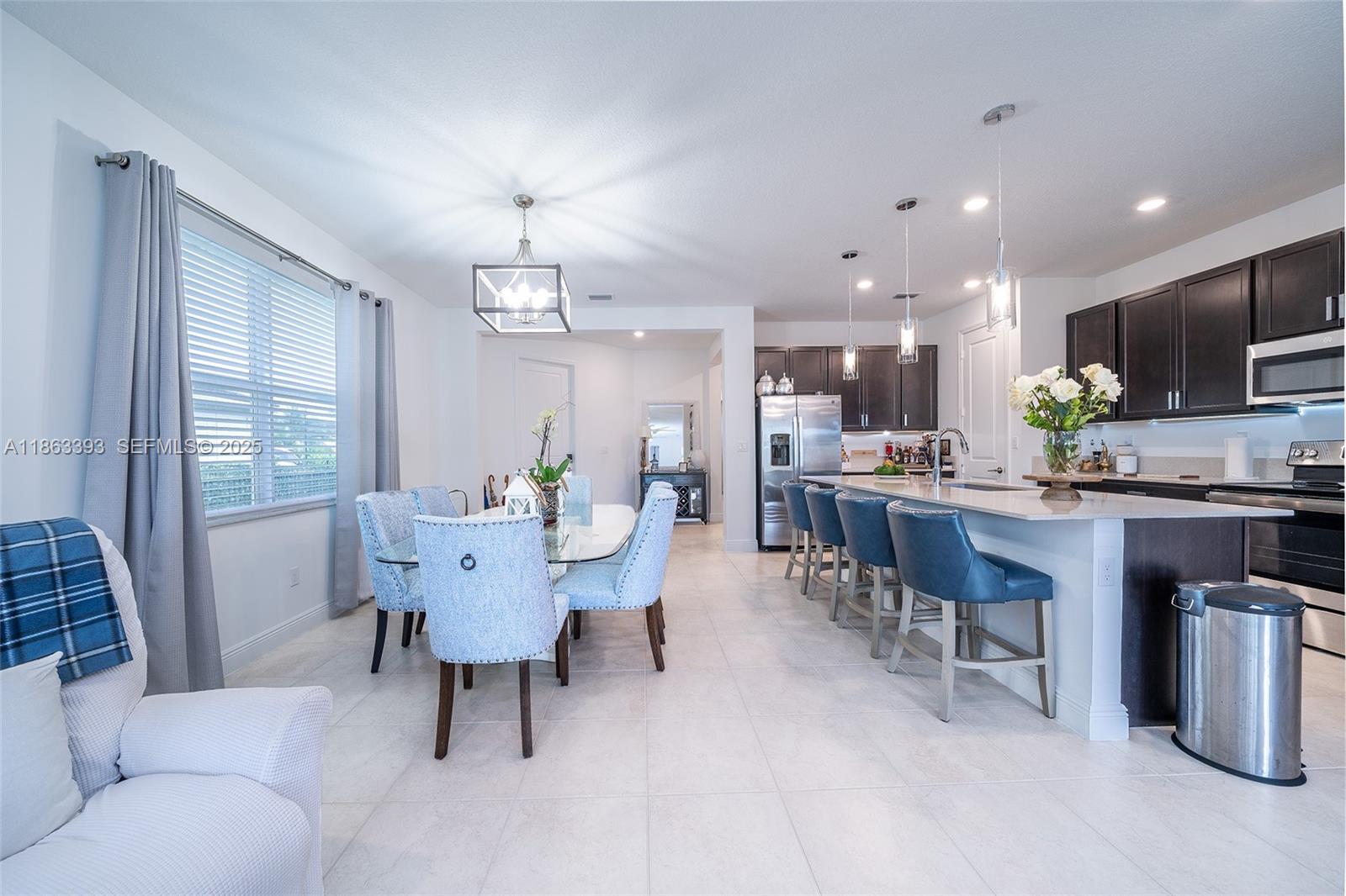 4230 Rosa Drive Deerfield Beach, FL 33064 - Photo 10 of 52 a view of a dining room with furniture window and outside view