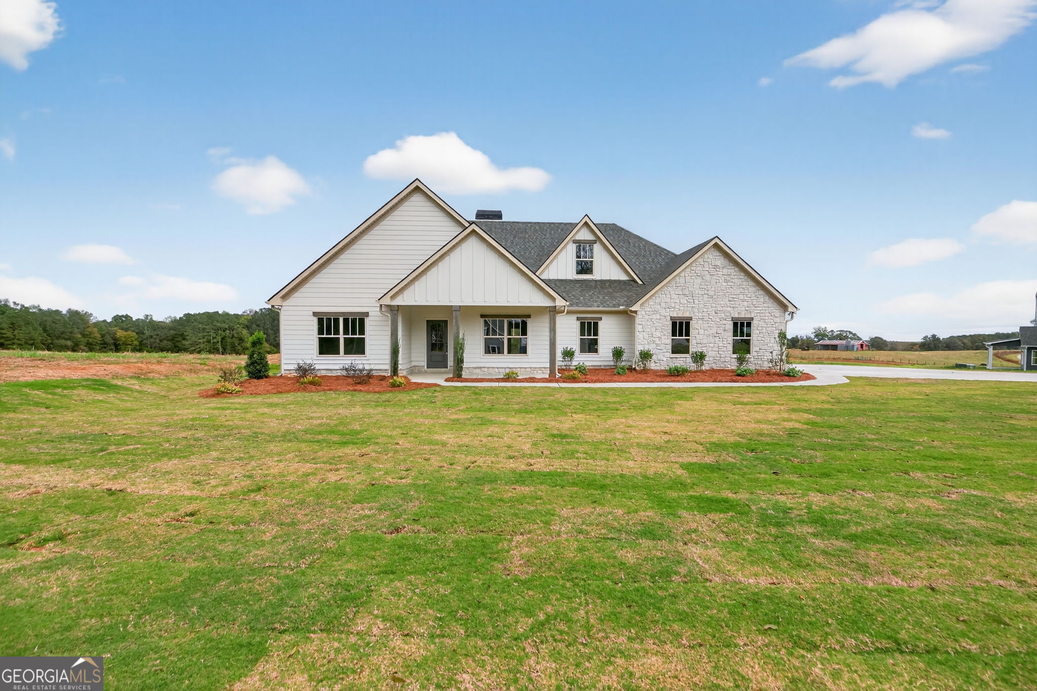 a view of house that has a big yard