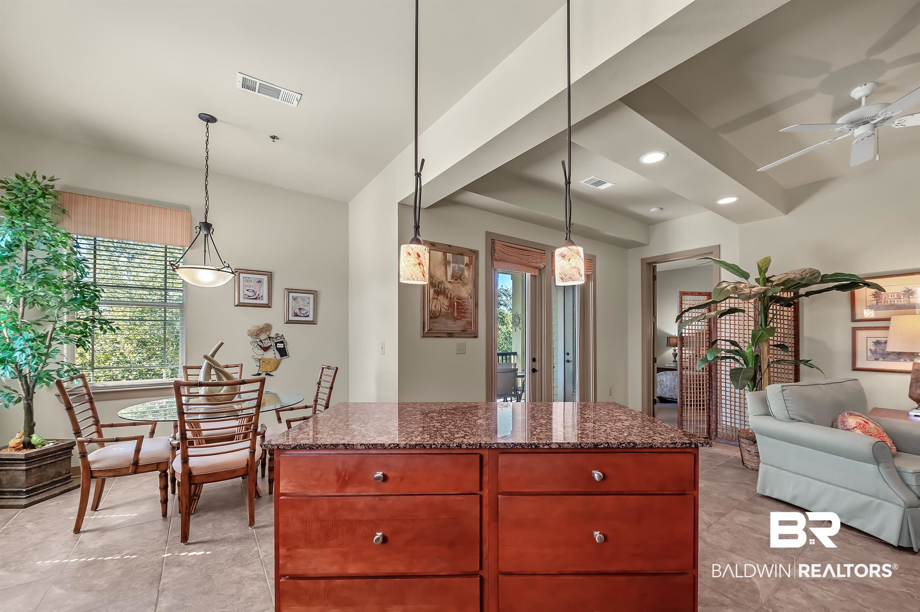 1430 Regency Road, Unit A301 Gulf Shores, AL 36542 - Photo 14 of 47 Kitchen featuring a kitchen island, ceiling fan, hanging light fixtures, and dark stone counters