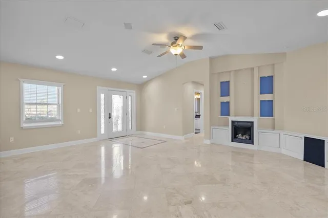 a view of an empty room with a ceiling fan