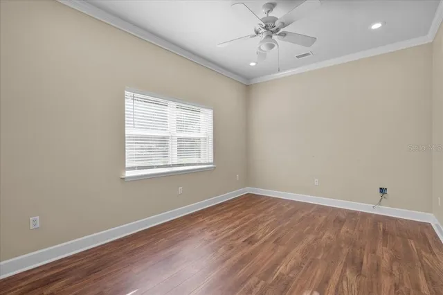 wooden floor in an empty room with a window