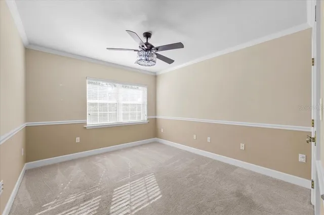 a view of a room with a ceiling fan