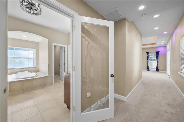 a view of an empty room with a ceiling fan