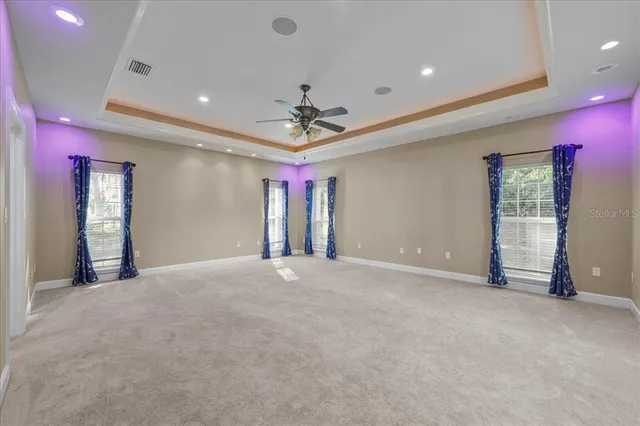 a view of an empty room with a ceiling fan