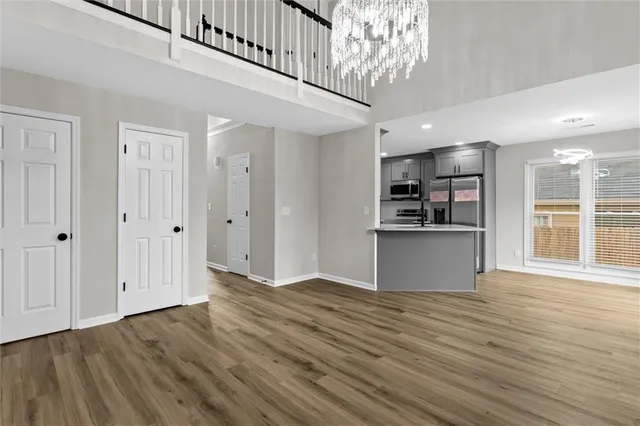 a view of a kitchen with wooden floor and a kitchen