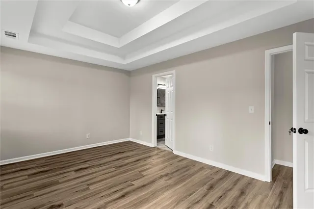 a view of an empty room with wooden floor