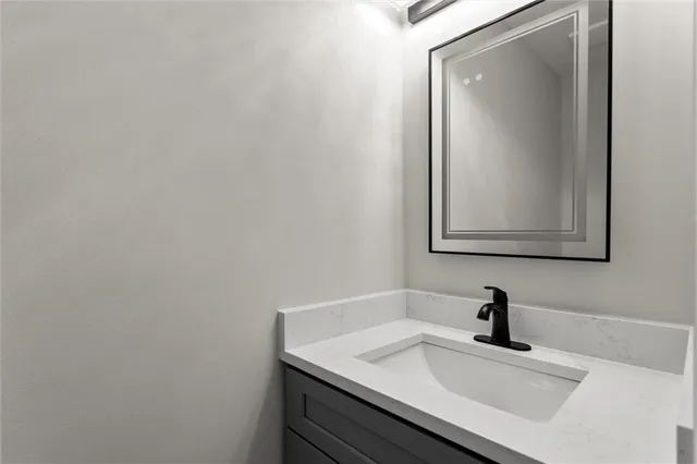 a bathroom with a sink vanity and a mirror