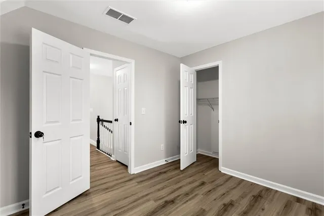 a view of an empty room with wooden floor