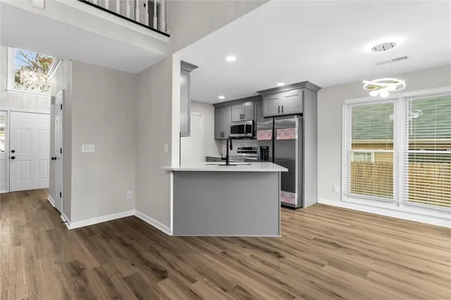 a view of kitchen with sink and refrigerator