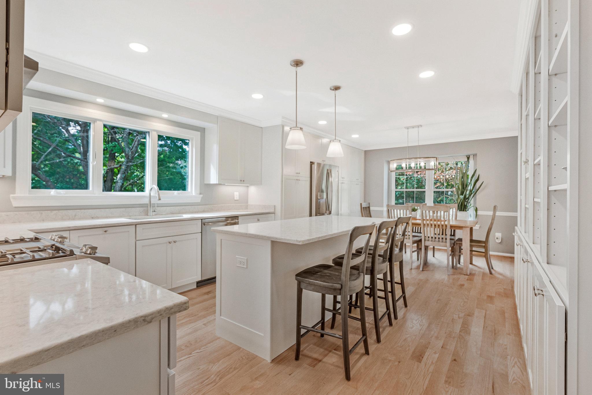7 South Lowery Court Sterling, VA 20165 - Photo 11 of 63 a kitchen with a table chairs stove and cabinets