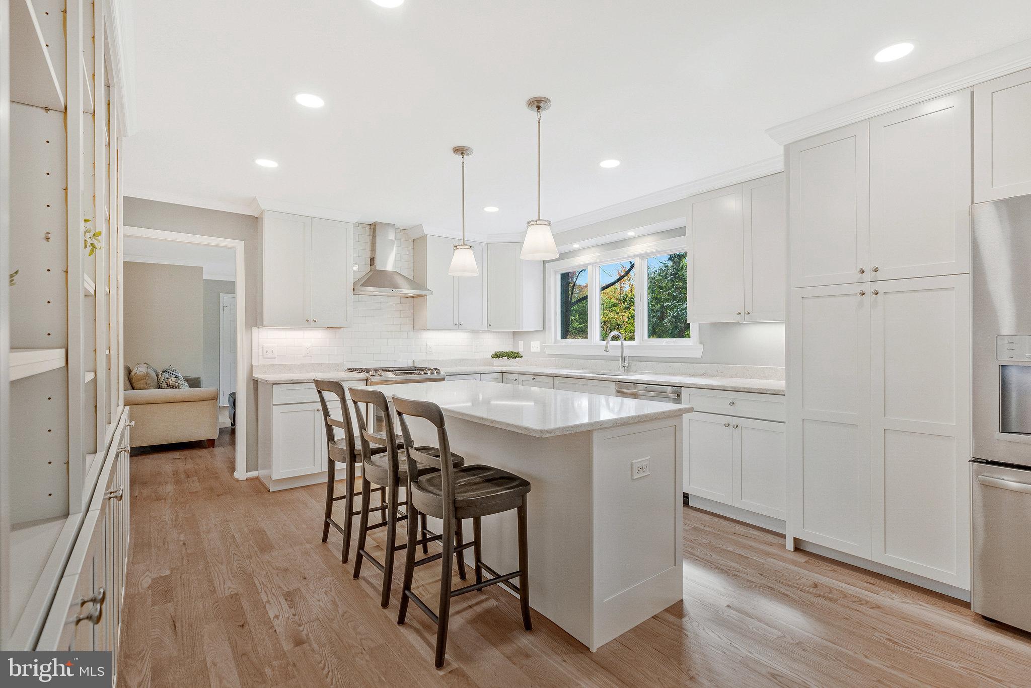 7 South Lowery Court Sterling, VA 20165 - Photo 15 of 63 a kitchen with stainless steel appliances granite countertop a table chairs sink and wooden floor
