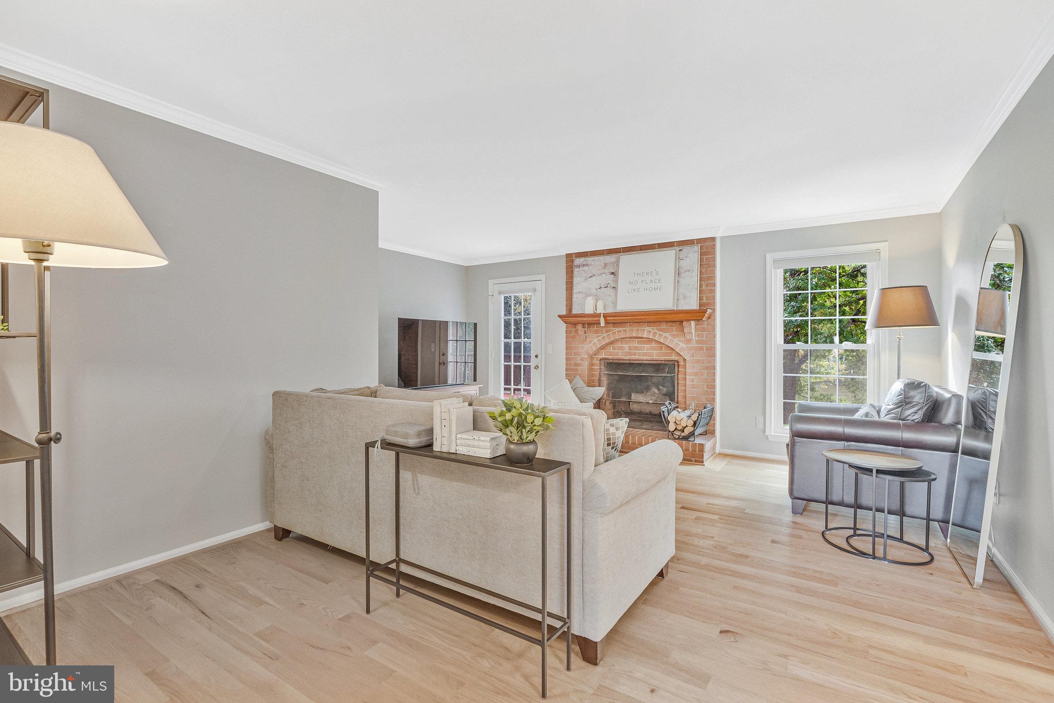 7 South Lowery Court Sterling, VA 20165 - Photo 19 of 63 a living room with furniture and a fireplace