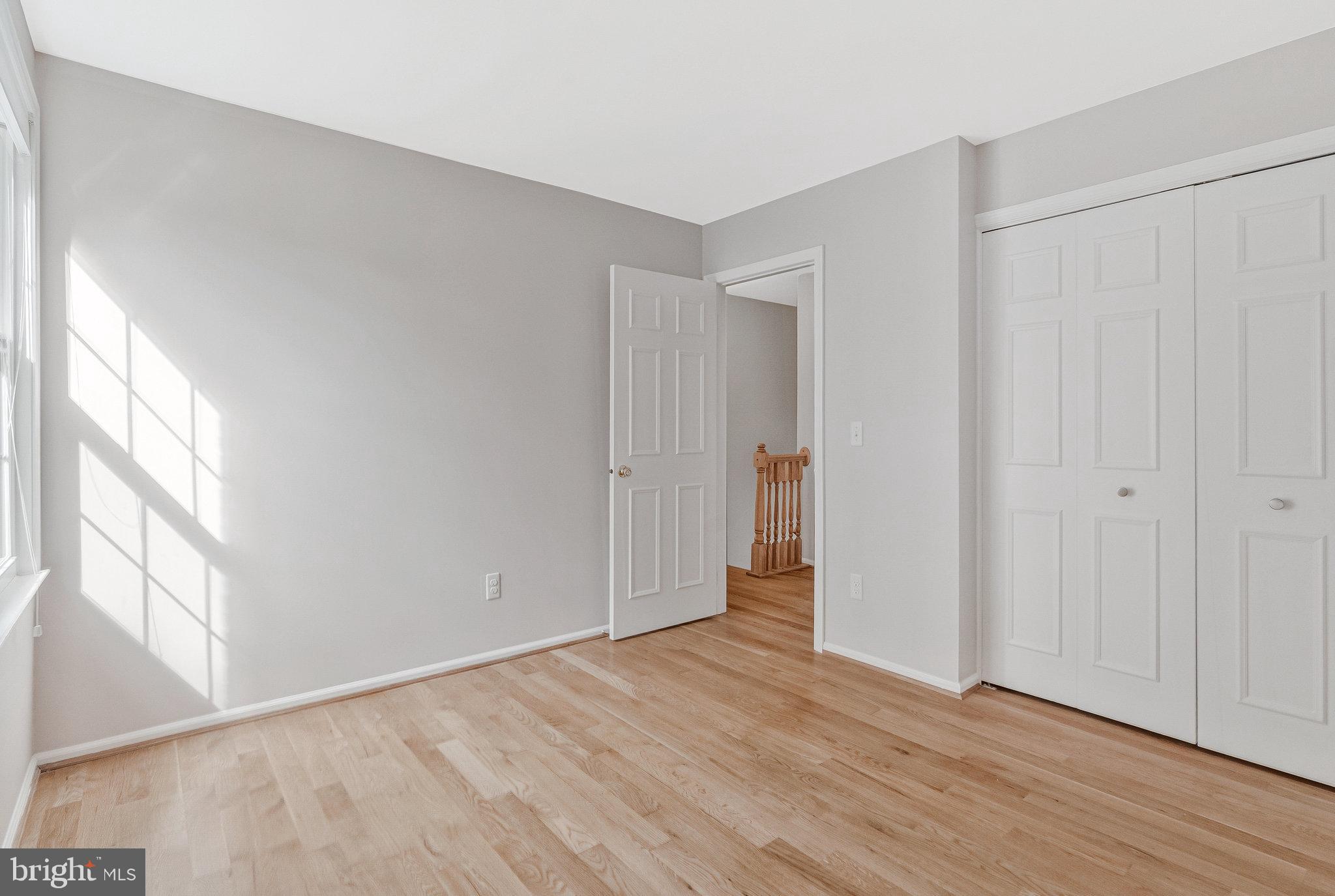 7 South Lowery Court Sterling, VA 20165 - Photo 34 of 63 a view of an empty room with wooden floor and a window