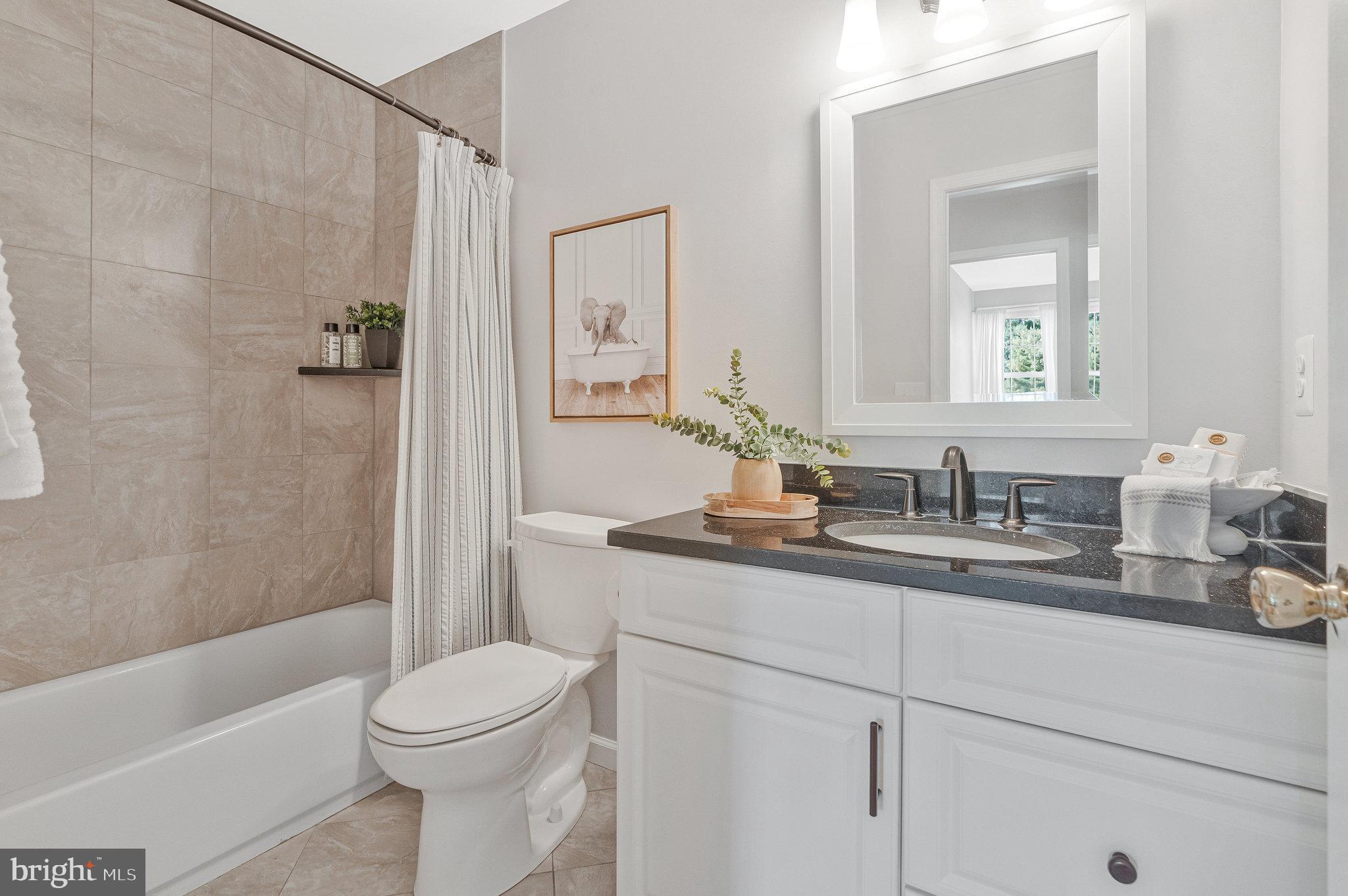 7 South Lowery Court Sterling, VA 20165 - Photo 36 of 63 a bathroom with a granite countertop sink a toilet and a bathtub