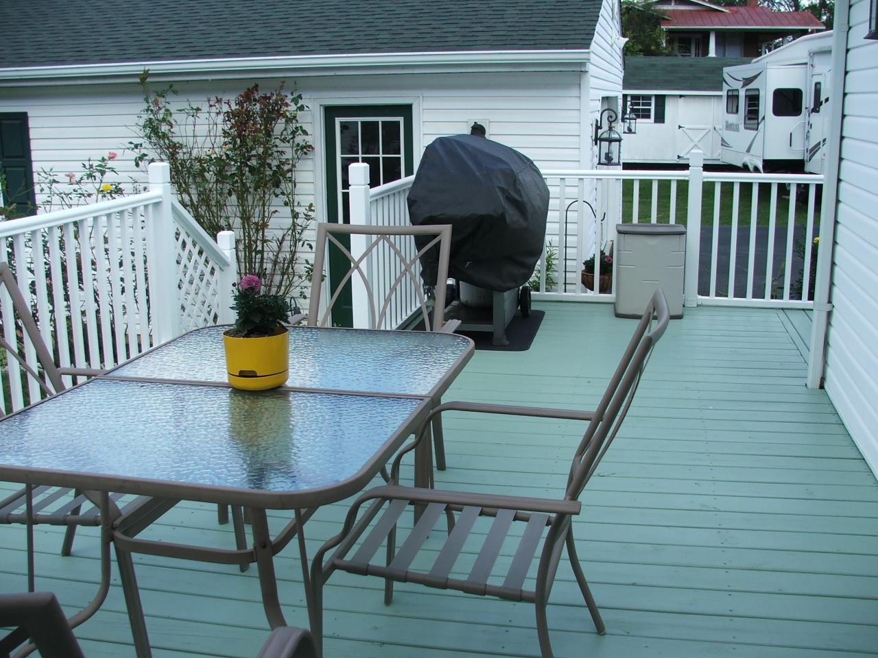 1124 Mountain View Road Vinton, VA 24179 - Photo 9 of 10 a view of a patio with table and chairs with wooden floor and fence