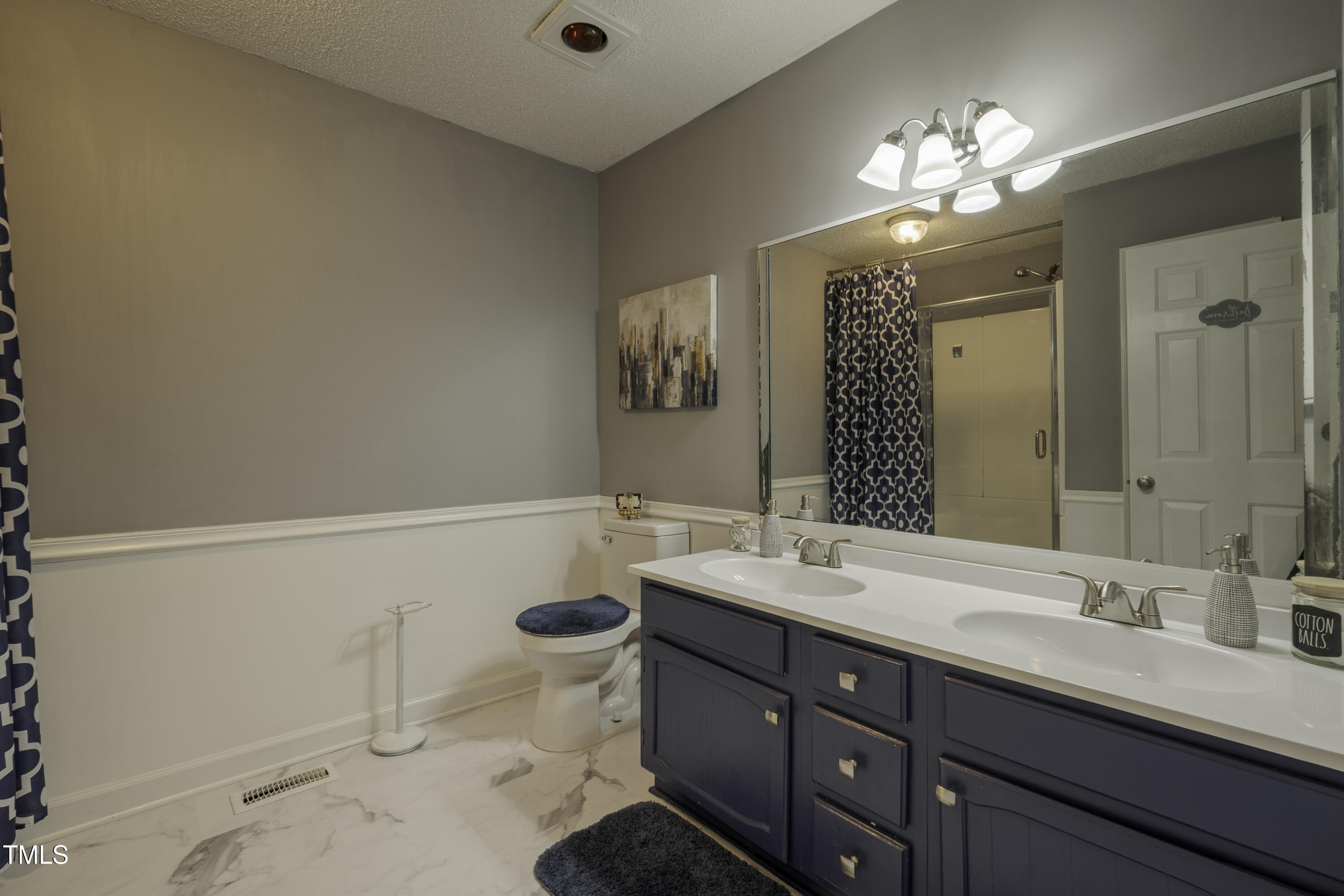 623 O B J Road Dunn, NC 28334 - Photo 16 of 36 a bathroom with a double vanity sink mirror and toilet