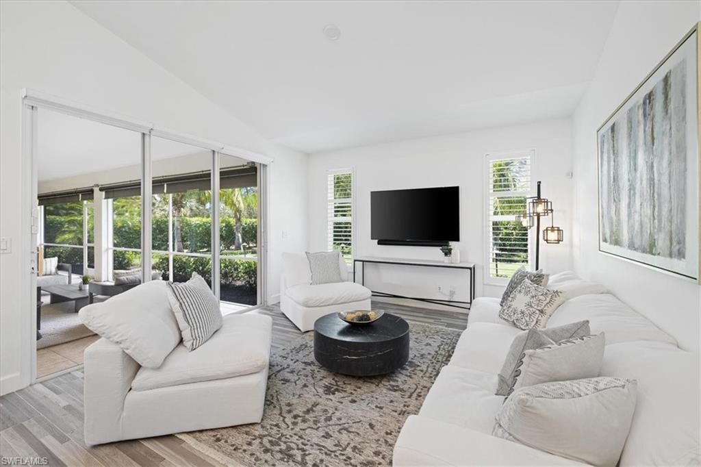 2032 Prince Drive Naples, FL 34110 - Photo 14 of 44 a living room with furniture and a flat screen tv