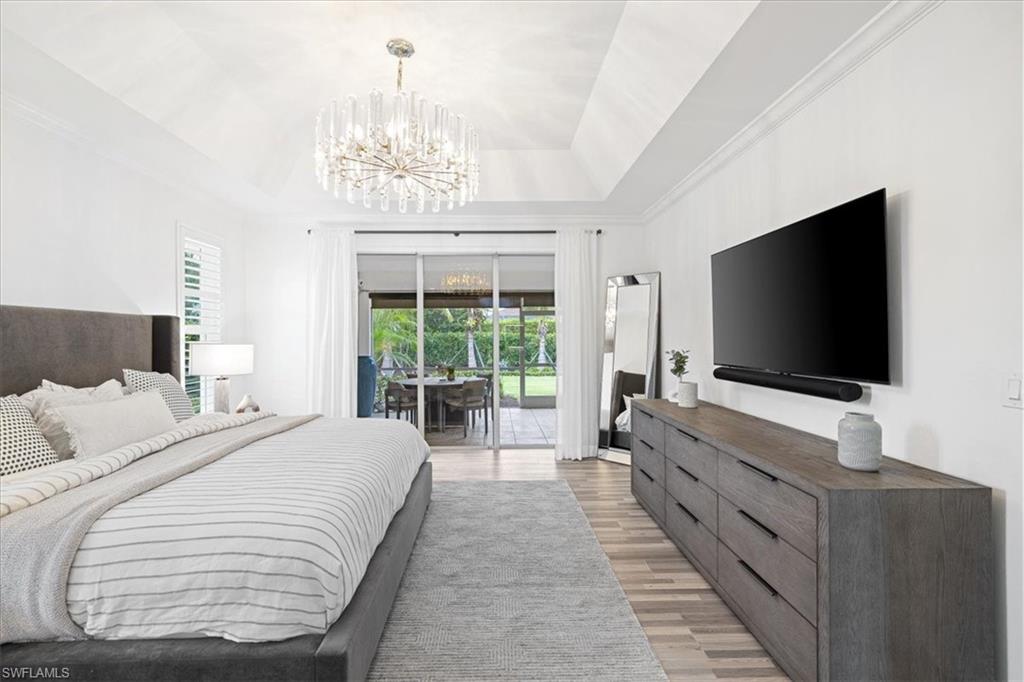 2032 Prince Drive Naples, FL 34110 - Photo 17 of 44 a bedroom with bed and a flat tv screen on dresser