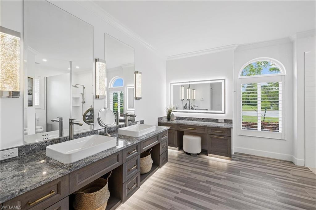2032 Prince Drive Naples, FL 34110 - Photo 18 of 44 a spacious bathroom with a granite countertop sink and a mirror