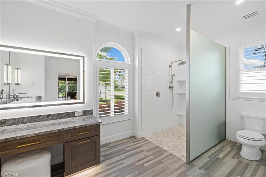 2032 Prince Drive Naples, FL 34110 - Photo 19 of 44 a bathroom with a sink and a large mirror