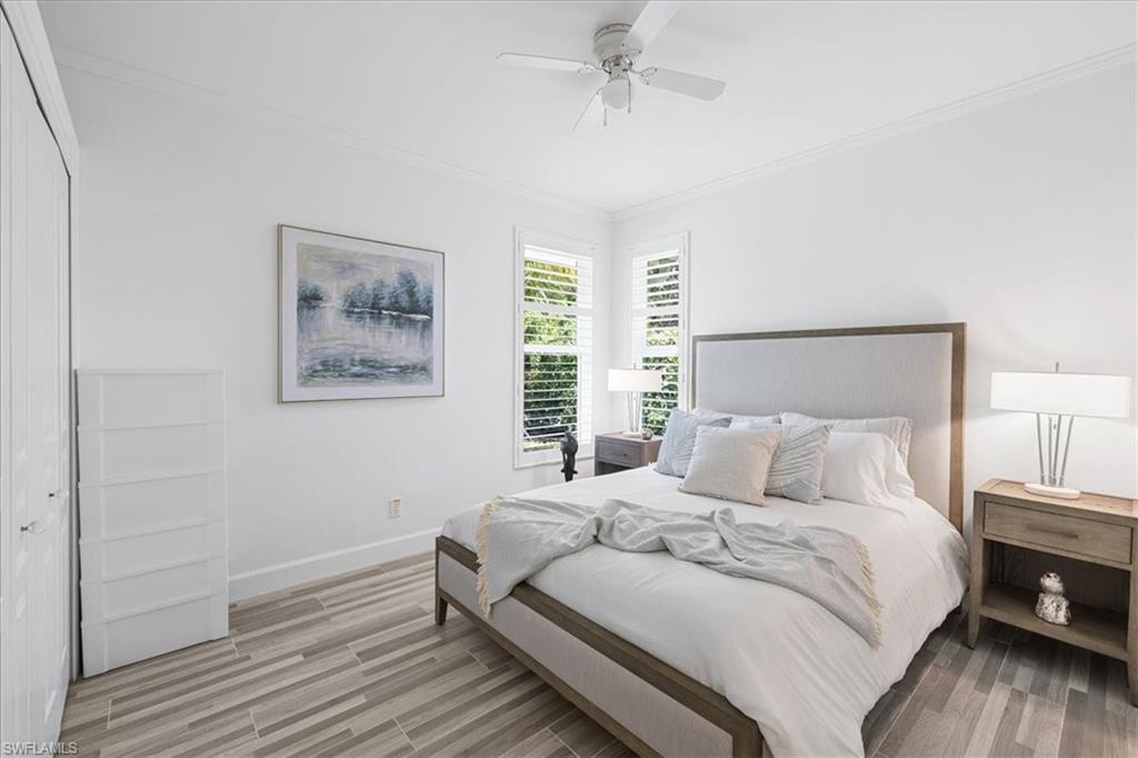 2032 Prince Drive Naples, FL 34110 - Photo 21 of 44 a bedroom with a bed and a night stand