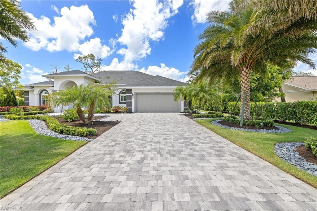 2032 Prince Drive Naples, FL 34110 - Photo 3 of 44 a front view of a house with garden