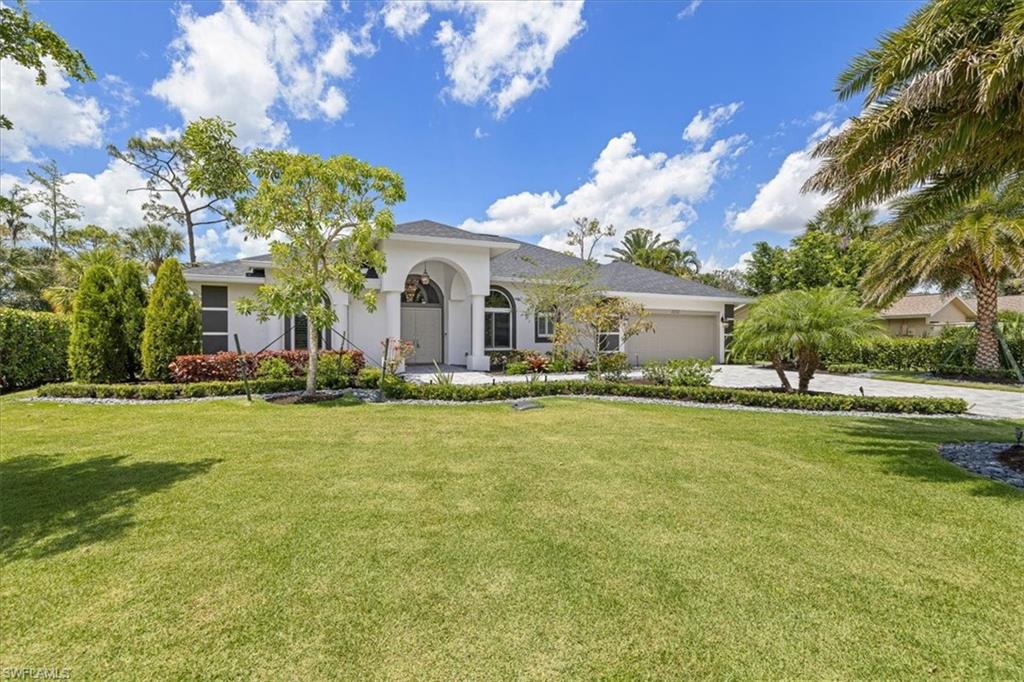 2032 Prince Drive Naples, FL 34110 - Photo 4 of 44 a front view of house with yard and seating area