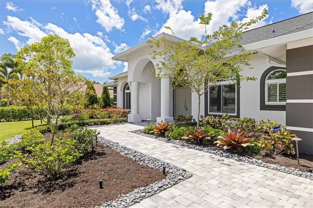 2032 Prince Drive Naples, FL 34110 - Photo 5 of 44 a front view of a house with a yard