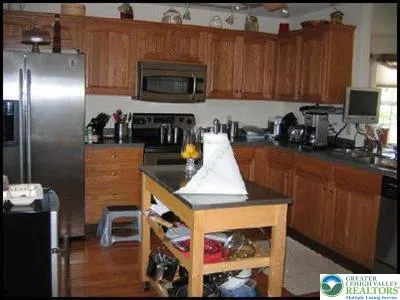 a kitchen with a refrigerator and a stove top oven