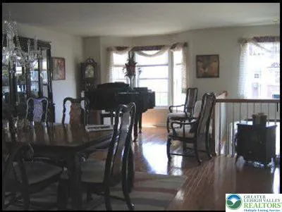 a view of a dining room with furniture and window
