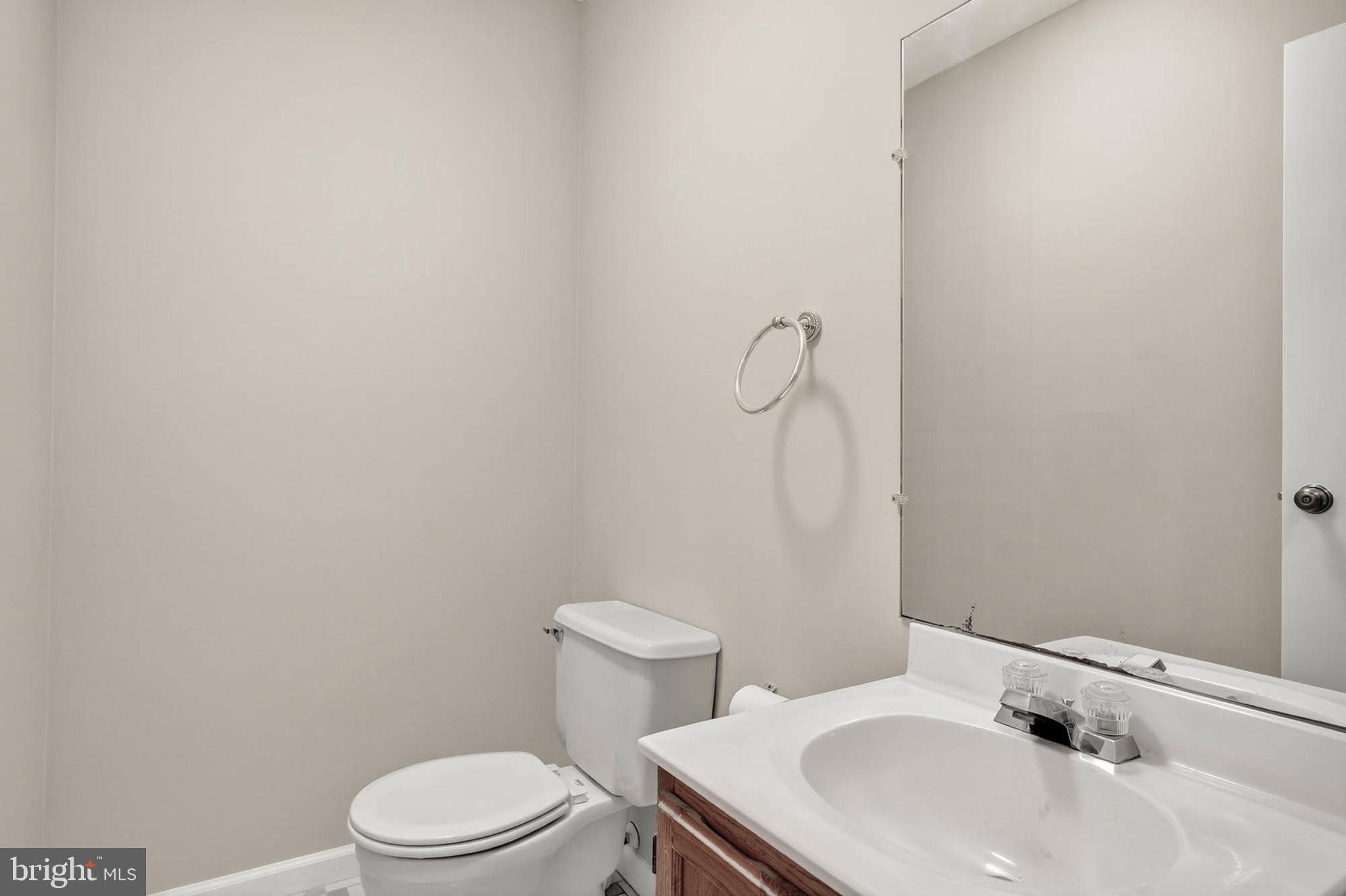 8203 Willow Street Laurel, MD 20707 - Photo 11 of 41 a bathroom with a sink a toilet and mirror