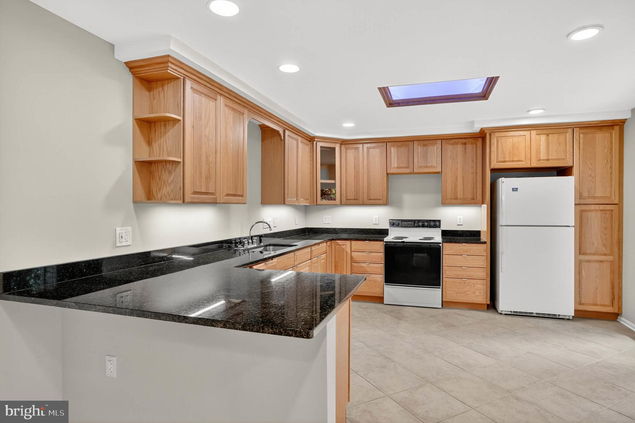 8203 Willow Street Laurel, MD 20707 - Photo 13 of 41 a kitchen with a refrigerator sink and cabinets