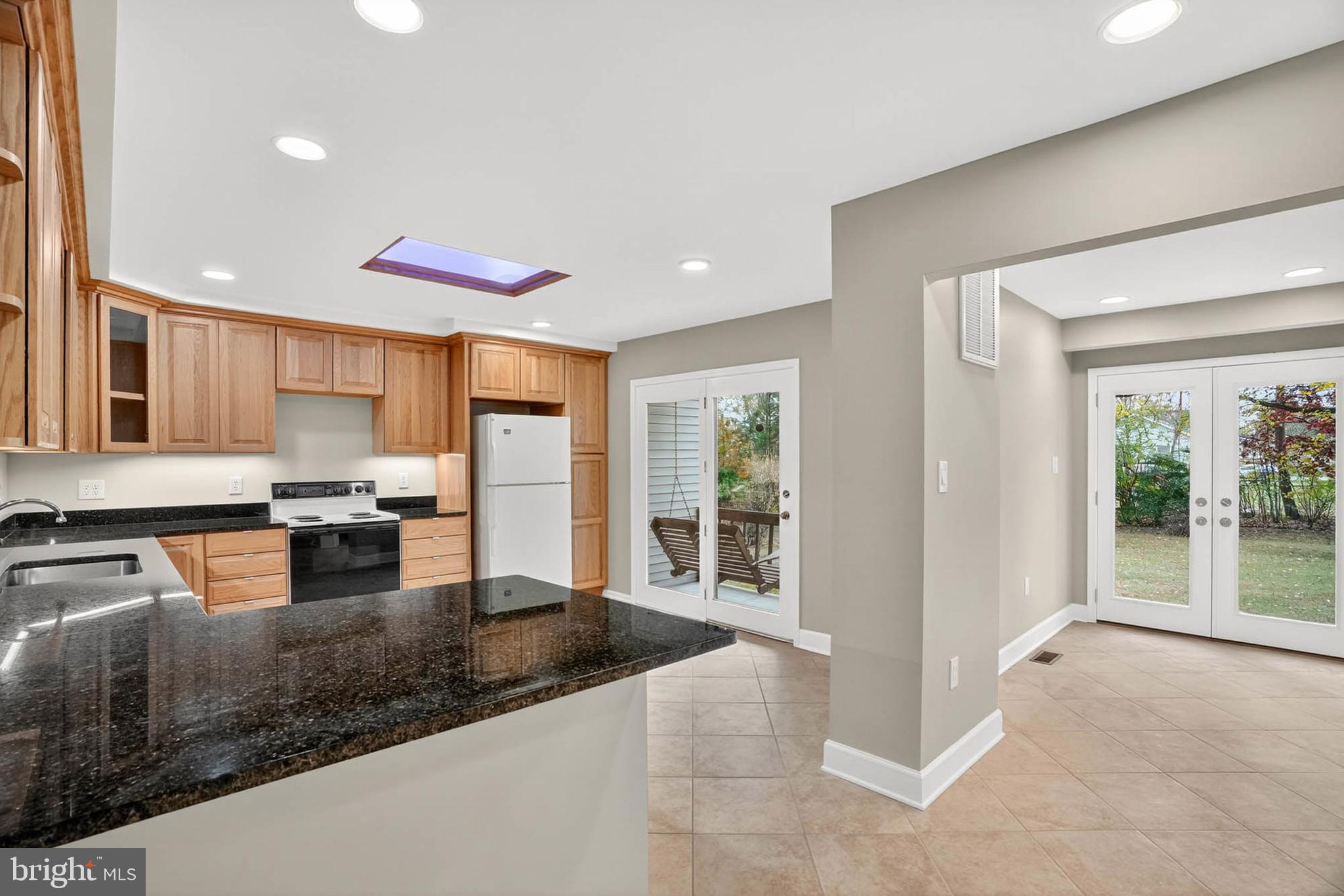 8203 Willow Street Laurel, MD 20707 - Photo 14 of 41 a kitchen with stainless steel appliances granite countertop a stove refrigerator and cabinets