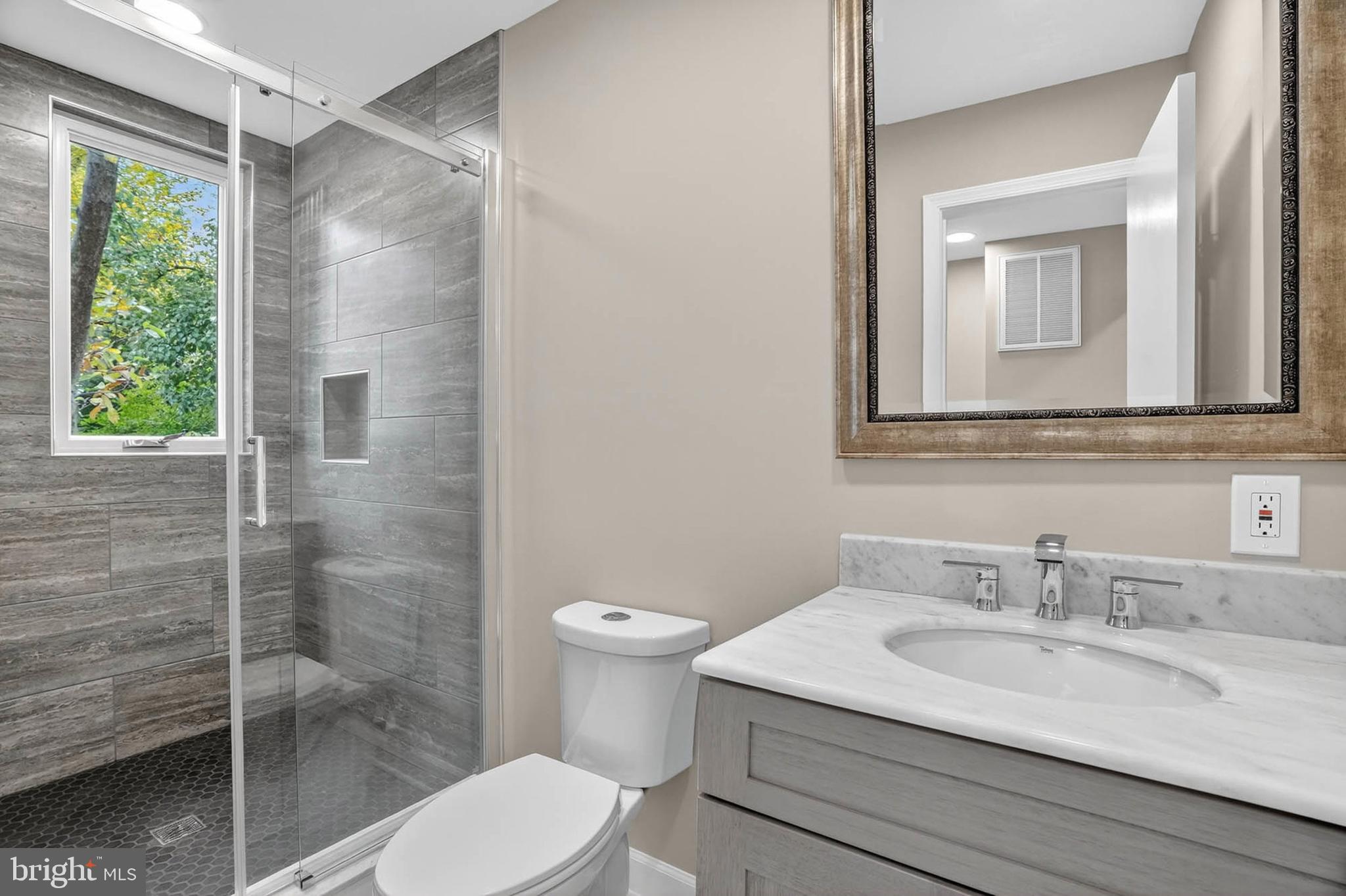 8203 Willow Street Laurel, MD 20707 - Photo 19 of 41 a bathroom with a sink toilet and shower