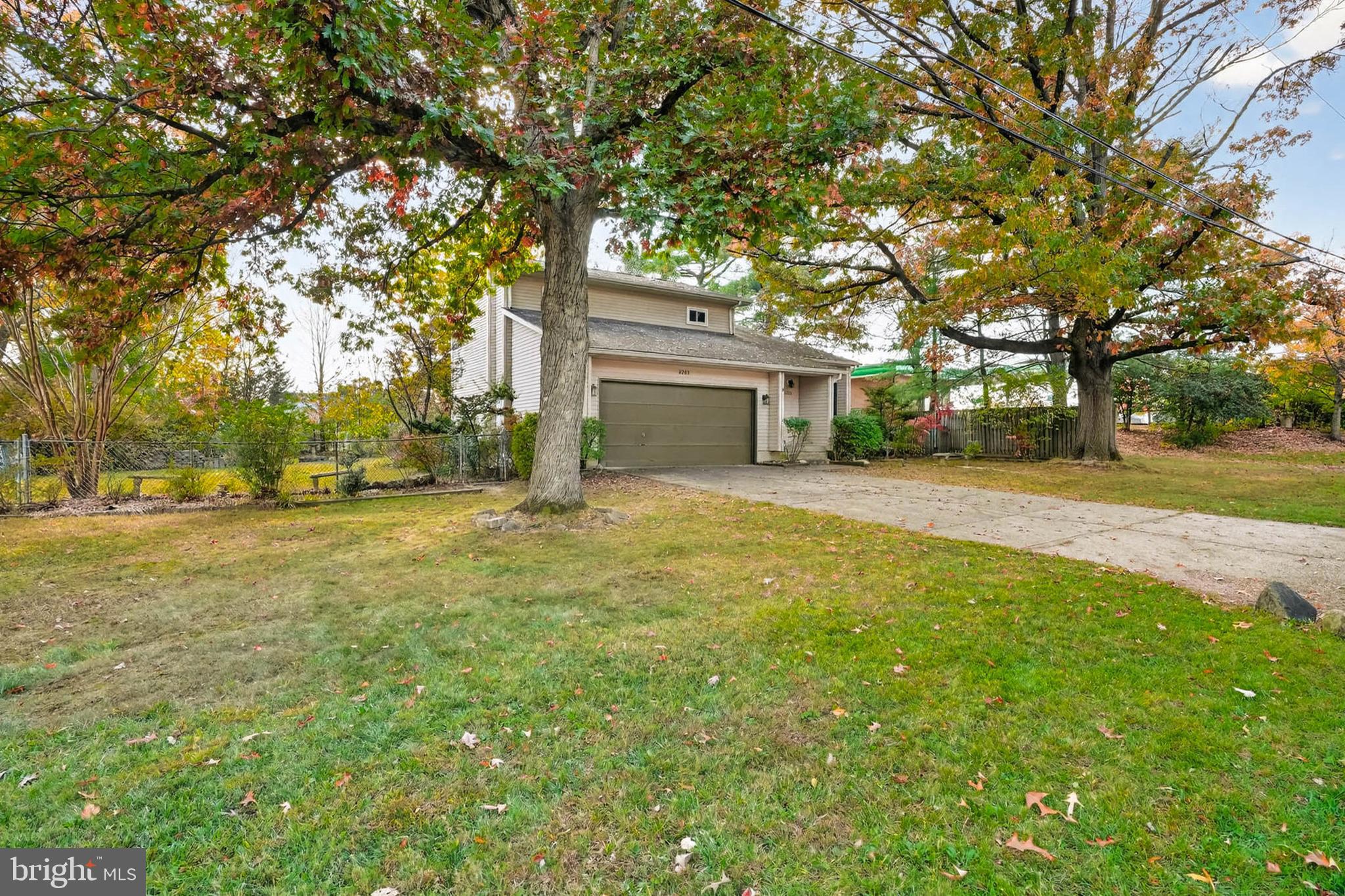 8203 Willow Street Laurel, MD 20707 - Photo 3 of 41 a yellow house with trees in front of it