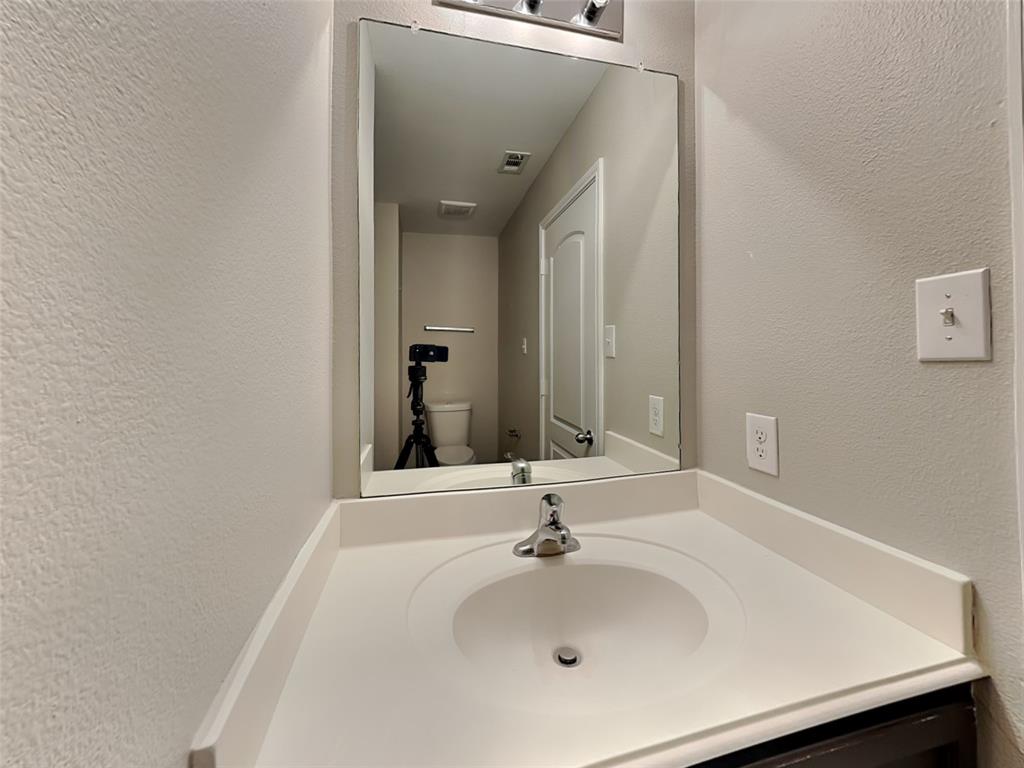 1334 Barrel Drive Dallas, TX 75253 - Photo 14 of 16 a bathroom with a sink and a mirror