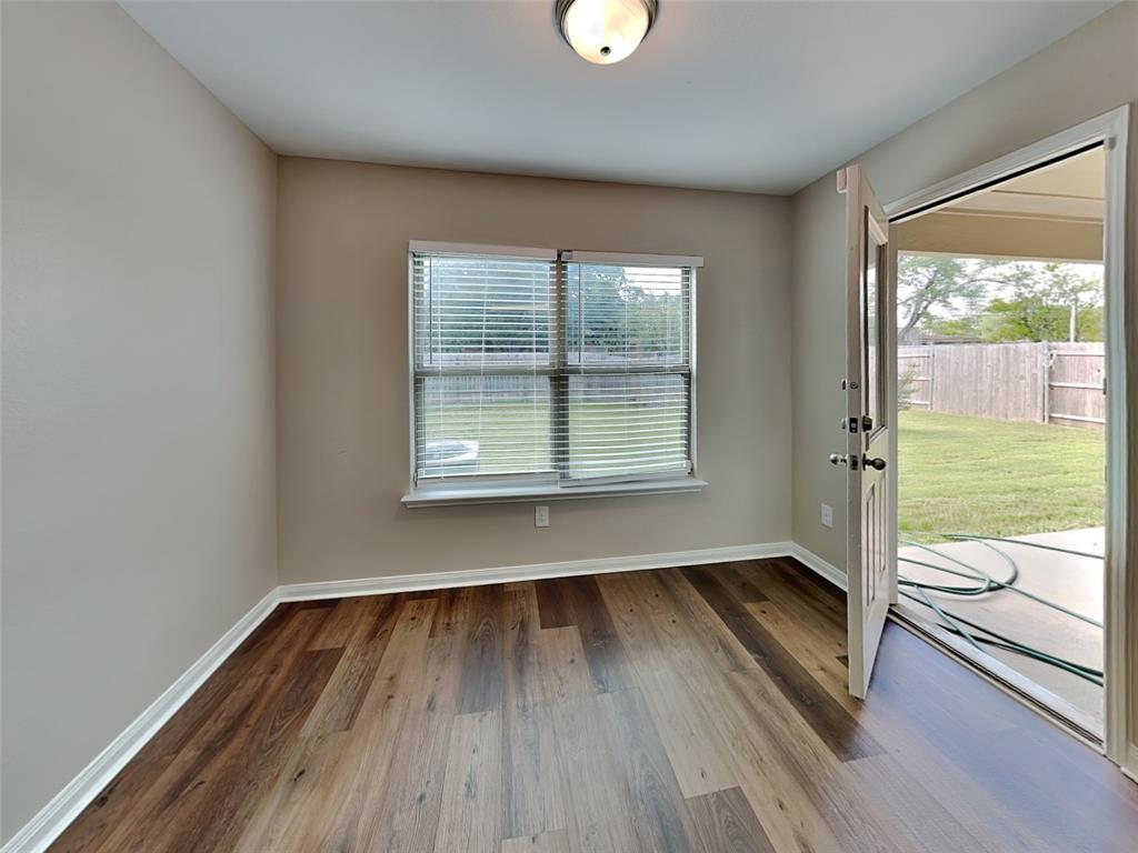 1334 Barrel Drive Dallas, TX 75253 - Photo 6 of 16 an empty room with wooden floor and windows