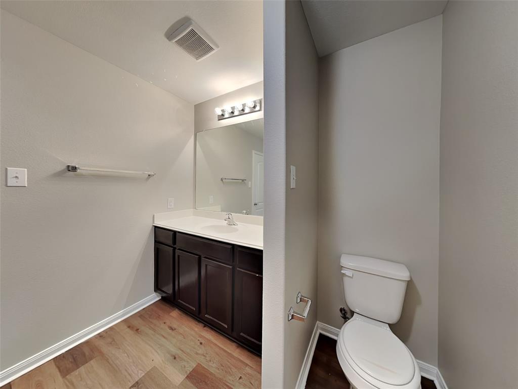 1334 Barrel Drive Dallas, TX 75253 - Photo 8 of 16 a bathroom with a toilet sink and mirror