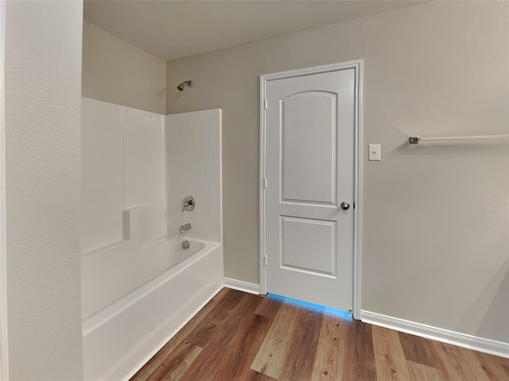 1334 Barrel Drive Dallas, TX 75253 - Photo 9 of 16 a bathroom with a bathtub and a shower