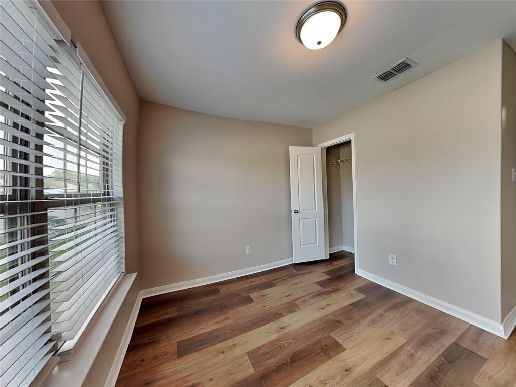 1334 Barrel Drive Dallas, TX 75253 - Photo 10 of 16 a view of an empty room with wooden floor and a window